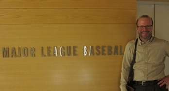 Photograph of Donald Gault consulting in the offices of the Commissioner of Major League Baseball